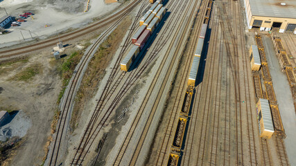 Aerial view of train tracks, trains, cargos.