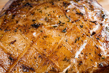 Roasted pork steak on a wooden board.