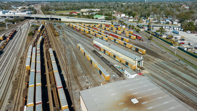 Aerial view of train tracks, trains, cargos.