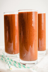 Three Coffee-Mocha Smoothies with Paper Straws: Group of breakfast smoothies made with coffee, cacao powder, and bananas