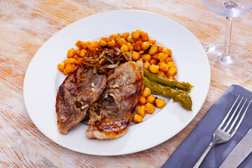 cuisine georgian roast lamb with beans and asparagus served on plate on wooden table
