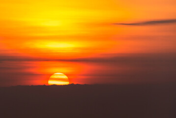 Fototapeta na wymiar Background of sunset sky concept : Big sun and Mist in sunrise, Morning