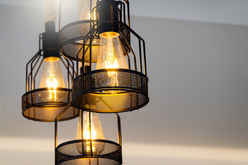 Vintage lamp hanging from the ceiling with white wall decorated in hotel