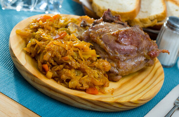 Oven baked pork cheeks garnished with stewed cabbage