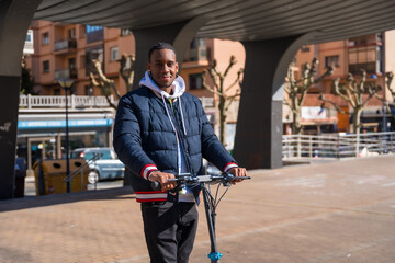 Black ethnic male skateboarding on an electric skate, new youth mobility