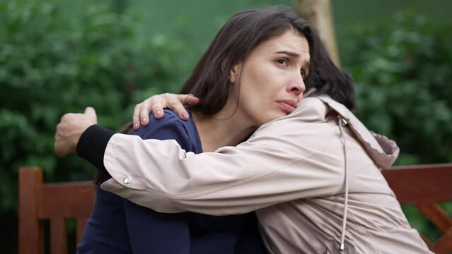 Depressed woman having HELP and SUPPORT from female companion. Two women hugging each other after tragedy