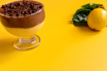 Passion fruit mousse with chocolate on yellow background
