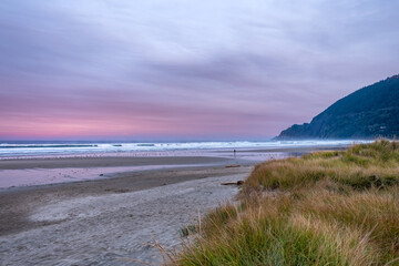 Fototapeta na wymiar Very early sunrise, with intense colors on the beach of Manzanita, Oregon, USA