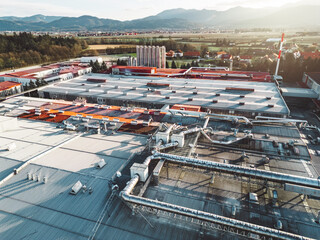 Sun is shining over a large logistic center building in the countryside 