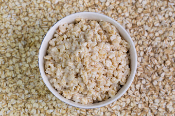 Healthy breakfast oatmeal porridge in bowl. Hot mashed oats, vegan vegetarian weight loss diet breakfast food