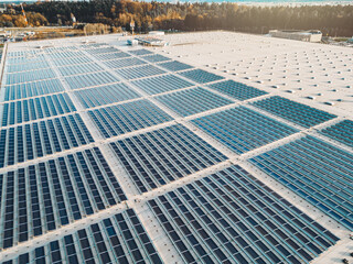 Solar panels stacked in lines on the roof top of distribution center 