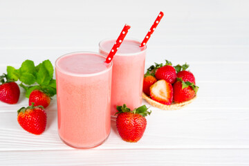 Strawberry yogurt fruit juice smoothie pink colorful fruit juice milkshake blend beverage healthy high protein the taste yummy In glass drink episode morning on white wood background.
