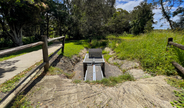 Metal water drain and fillter rubbish in park.