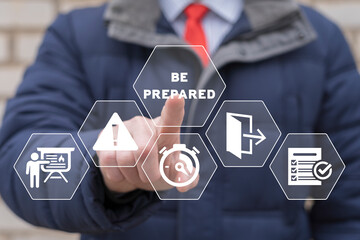 Businessman using virtual touchscreen presses inscription: BE PREPARED. Concept of Emergency Preparedness Plan. Business Evacuation Training. Emergency preparedness instructions planning for safety.