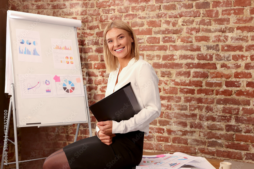 Poster Businesswoman near flipchart board in office. Lady boss