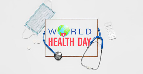 Clipboard with stethoscope, medical mask and pills on light background. World Health Day