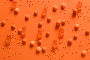 Different candies on orange background