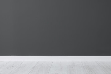 Beautiful dark grey wall and wooden floor in clean empty room