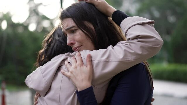 Friend giving empathic hug to depressed woman. Affectionate person embracing supportive girl