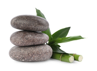 Stack of spa stones and bamboo on white background