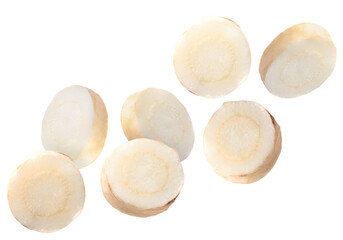 Slices of fresh parsley root falling on white background