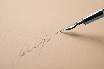 Signing on sheet of paper with fountain pen, closeup. Space for text