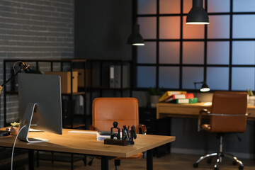 Accountant's workplace with computer in dark office