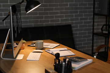 Accountant's workplace with computer in dark office