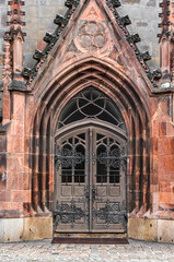 Fototapeta na wymiar View of old Gothic building with beautiful door