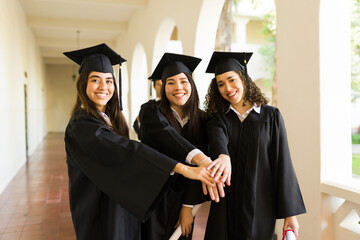 Portrait of best friends excited during their college graduation