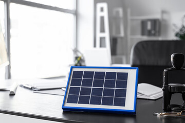 Portable solar panel on table in office, closeup