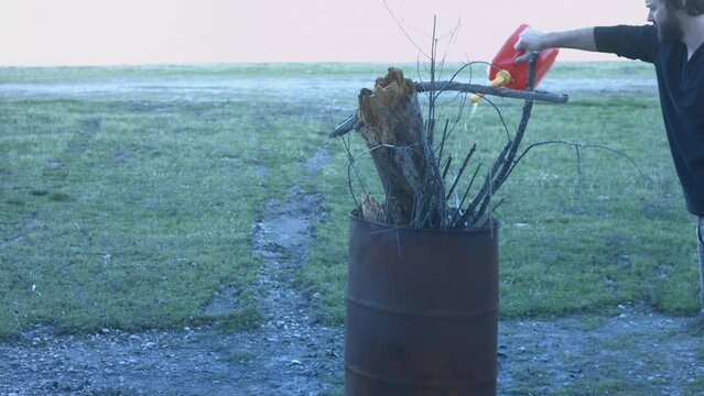 Young Man Tending Trash Can Fire in Rural Tennessee USA BMPC4K