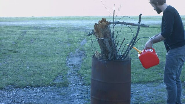 Young Man Tending Trash Can Fire in Rural Tennessee USA BMPC4K