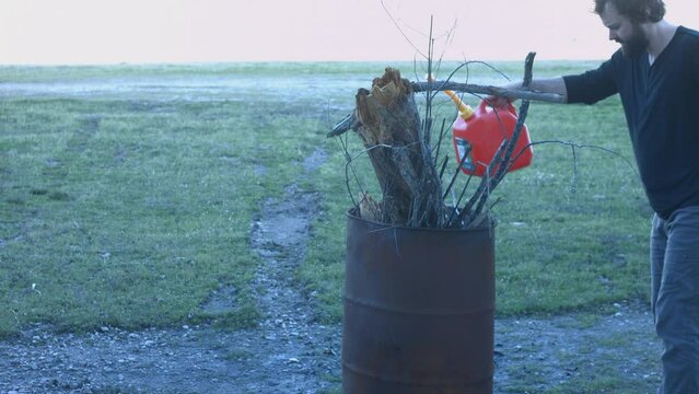 Young Man Tending Trash Can Fire in Rural Tennessee USA BMPC4K