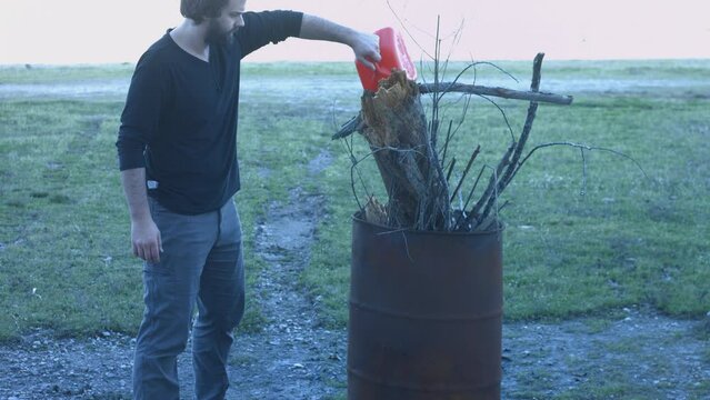 Young Man Tending Trash Can Fire in Rural Tennessee USA BMPC4K
