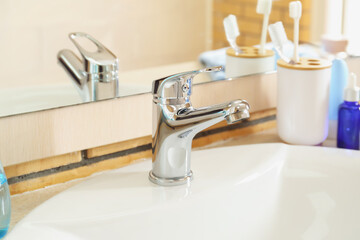 White ceramic sink near mirror, closeup