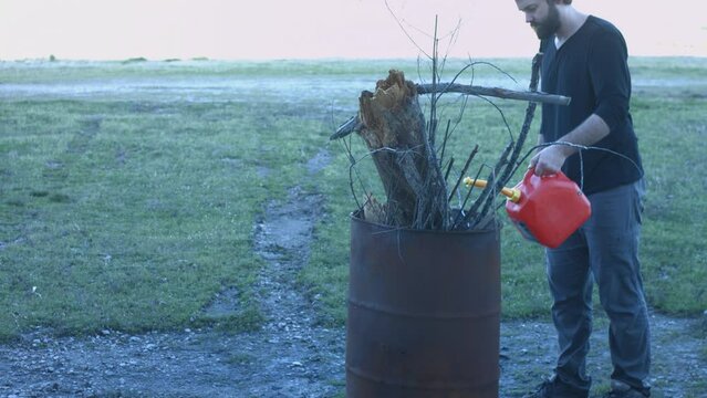 Young Man Tending Trash Can Fire in Rural Tennessee USA BMPC4K