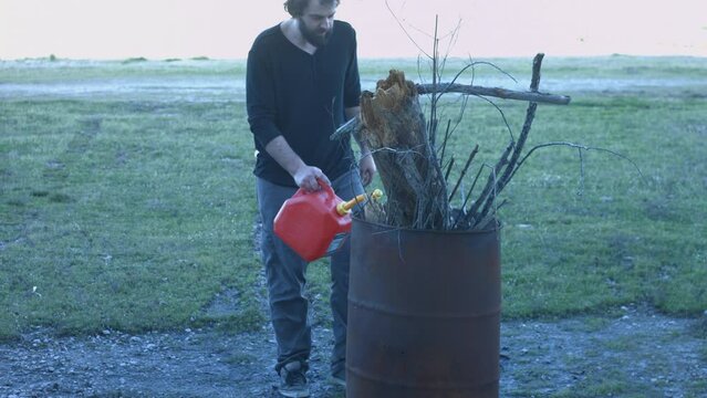 Young Man Tending Trash Can Fire in Rural Tennessee USA BMPC4K