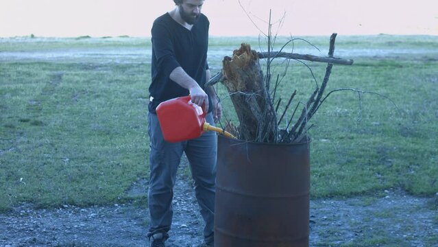 Young Man Tending Trash Can Fire in Rural Tennessee USA BMPC4K