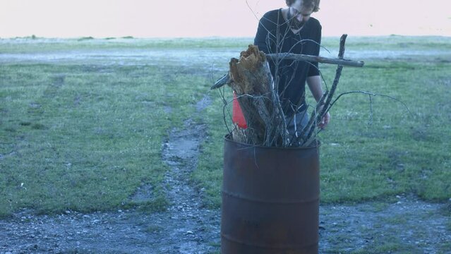 Young Man Tending Trash Can Fire in Rural Tennessee USA BMPC4K