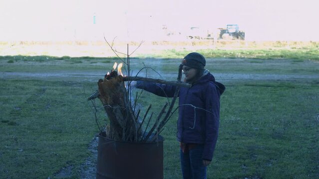 Young Man Tending Trash Can Fire in Rural Tennessee USA BMPC4K