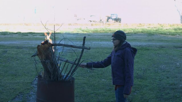 Young Man Tending Trash Can Fire in Rural Tennessee USA BMPC4K
