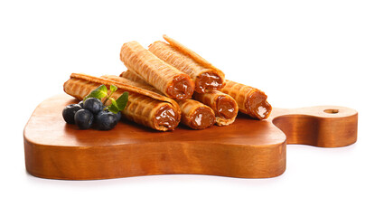 Fototapeta na wymiar Board with delicious wafer rolls and blueberries isolated on white background