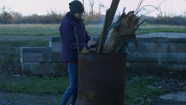 Young Person Tending Trash Can Fire in Rural Tennessee USA BMPC4K