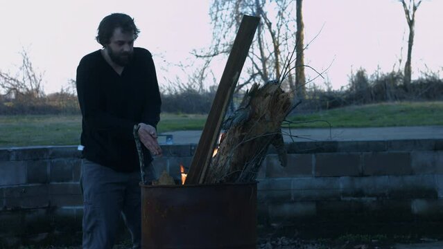 Young Person Tending Trash Can Fire in Rural Tennessee USA BMPC4K
