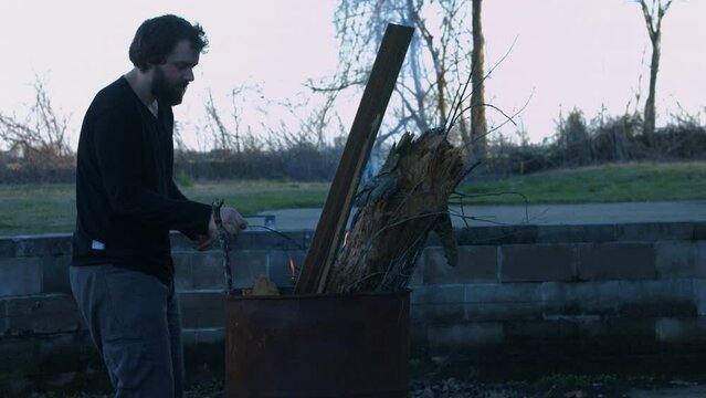 Young Person Tending Trash Can Fire in Rural Tennessee USA BMPC4K