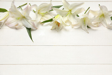 Composition with beautiful lily flowers on light wooden background