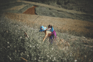 Ethnic woman and child working on the rice field