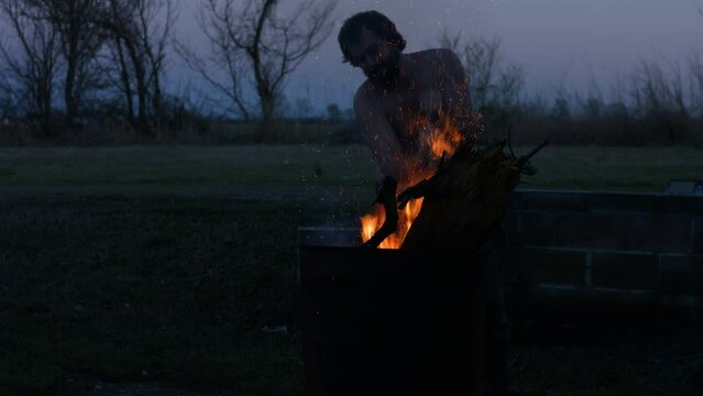 Young Man Tending Trash Can Fire in Rural Tennessee USA BMPC4K