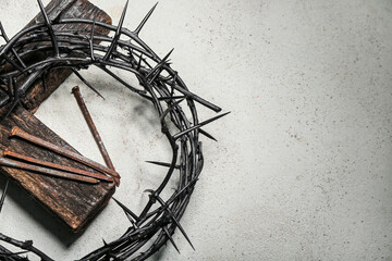 Crown of thorns, wooden cross and nails on grunge background